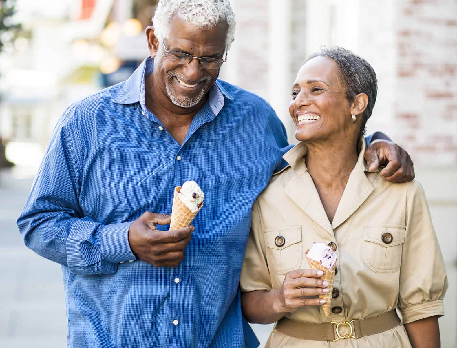 couple-walking-down-street-eating-ice-cream